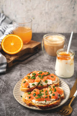 Cheese and salmon toasts, breakfast concept with coffee and freshly squeezed orange juice, healthy food.