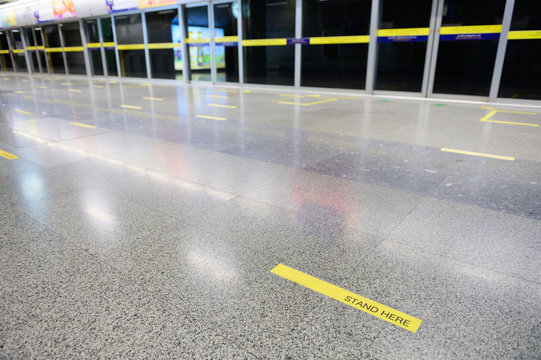 Subway Platform Against A Yellow Line With Words 