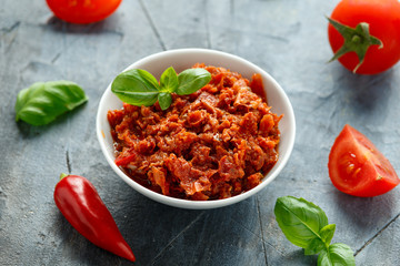 Sun dried tomato pesto in white bowl.