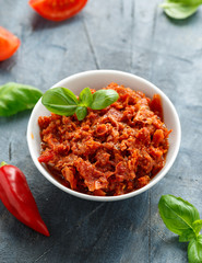 Sun dried tomato pesto in white bowl.