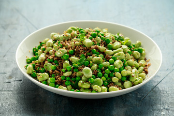Green Broad beans and quinoa salad with sweet peas and mint. Healthy vegan food
