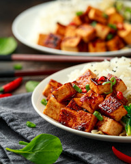 Fried Asian tofu in sweet chilli glaze served with rice, steamed spinach and beansprouts. Vegetable healthy food