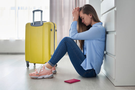 Frustrated Upset Woman Traveler With Yellow Suitcase Affected By Flight Delay And Cancellation Travel And Vacation Weekends. Travel Ban And Traveling Problems