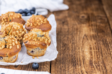 Some Blueberry Muffins (close-up shot; selective focus)