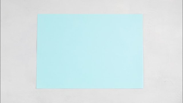 Stop motion animation with unwrapped blue paper with copy space