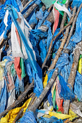 Flags in the wind. Ovoo are sacred stone heaps used as altars or shrines in Mongolian folk religious practices.