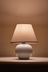 Small lamp glowing in bedroom, close up