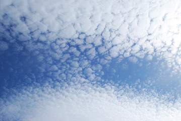 
delicate patterns of white clouds in the blue sky