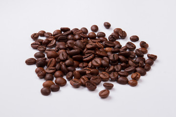 Heap of fresh roasted coffee beans. Isolated on white background