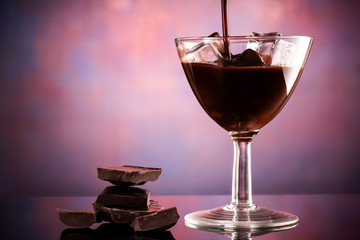 glass of coffee liqueur with ice cubes