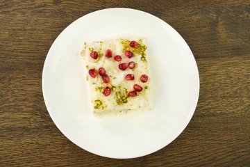 Traditional Turkish Ramadan Dessert Gullac . It is made with gullac (rice wafer or rice sheets) , milk, rose water, walnut, vanilla.  It is decorated with pomegranate and pistachio.
