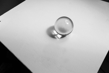 Glass ball on white and black geometric background spiritual  concept
