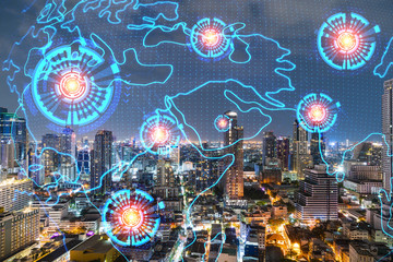 Multi exposure of Bangkok cityscape night time background and world map hologram. Concept of media networking.