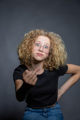 teen girl  in black shirt with curley hair flips sb the bird