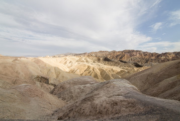 Fototapeta na wymiar Panoramic view on Zabriskie Point in Death Valley with colorful rock formations - View panoramic landscape of death valley