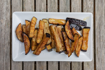 fried eggplant with salt and honey on a white tray