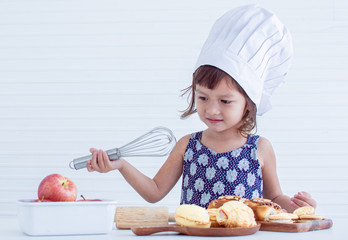 A little girl is making bakery