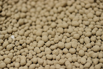 Magnesium lime fertilizer or fertiliser background, chemical granulated fertilizer closeup. Macroelements and microelements for agricultural plants