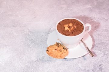 Cramped chocolate with nuts and cookies close-up. Tasty drink.