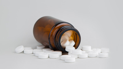 white pills on a white background, a jar of pills