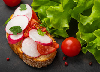 Italian tomato bruschetta with chopped vegetables, herbs and oil on grilled or toasted crusty ciabatta bread