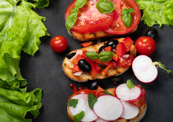 Italian tomato bruschetta with chopped vegetables, herbs and oil on grilled or toasted crusty ciabatta bread
