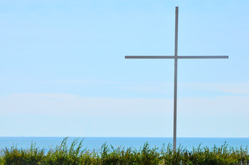 Fototapeta na wymiar iron cross against the sky. christian symbol on natural background