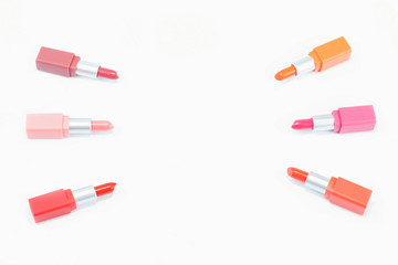 top view of colorful pastel lipstick arranged on white background with copy space