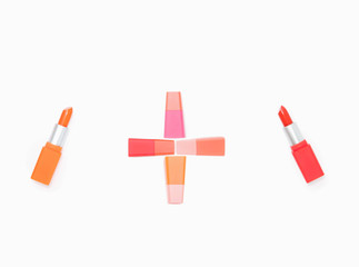 Orange lipstick and the plus sign with red lipstick isolate on white background