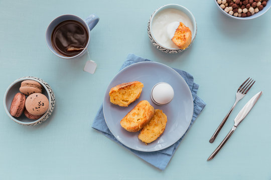 French fried toast with tea, boiled eggs and fresh yogurt. Tasty farmer breakfast.