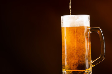 mug of beer on dark background