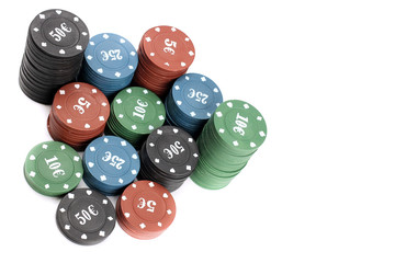 Stacks of poker chips of four denominations are isolated on a white background, top view