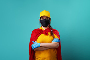 Courier is wearing in superhero cloak and protected face mask.