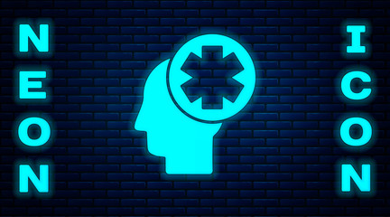 Glowing neon Male head with hospital icon isolated on brick wall background. Head with mental health, healthcare and medical sign.  Vector Illustration