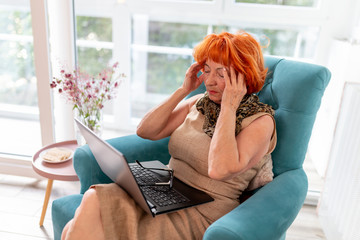 Elderly woman having a headache