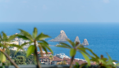 Landscape of the Sicilian seashes, sea views with horizon and city view, Faraglioni