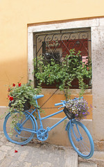 Fototapeta na wymiar An ornament bike with pots in a street of Rovinj, Croatia
