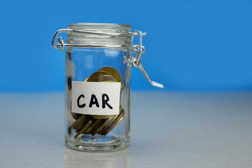 Car word on piggy Bank, moneybox, money jar with coins