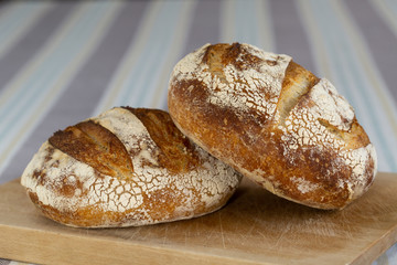 Freshly baked homemade sourdough bread on a wooden board