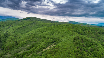 Obraz premium Spring landscape in mountains and the dark blue sky with clouds. A drone shot.
