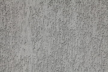 Grey wall, texture, background. Plastered building wall, painted with water-based paint. Decorated...