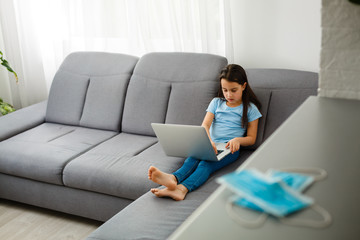 Little Girl Using Digital Laptop E-learning Concept. little girl children using laptop computer, studying through online e-learning system.