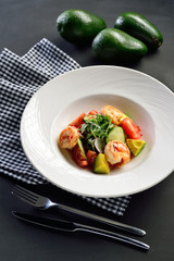 salad with shrimp, vegetables and avocado, diet healthy food, healthy eating concept, black background