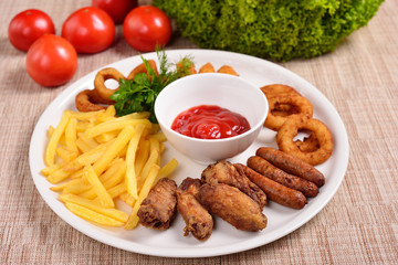 set of beer snacks, fried potatoes, nuggets and sauce