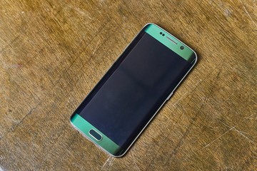 Smartphone on an old desk, turned off