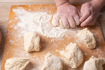 Female hands mixing dough in the home kitchen.