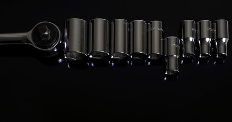 Ratchets and nozzles   on a black background. Professional instrument. Lettering - Chrome Vanadium