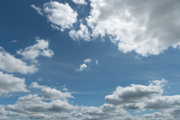 Blue clouds in the sky. Warm sunny day.