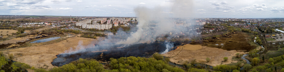 Fototapeta na wymiar Large-scale fire in the field, lots of smoke and fire Rivne