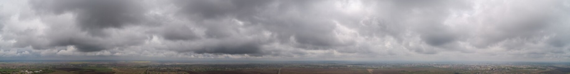 The stormy clouds on sunset panorama